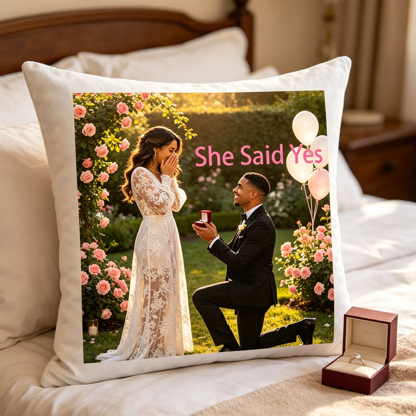 Custom engagement photo pillow resting on a plush white bed, next to a velvet engagement ring box. A romantic addition to the master bedroom, celebrating the couple’s “She Said Yes” moment.