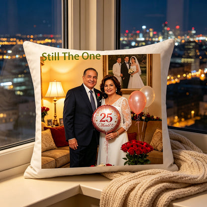Custom wedding anniversary photo pillow placed on a windowsill overlooking a glowing city skyline at dusk, next to a soft knit blanket. A peaceful, romantic touch celebrating the couple’s love against the city lights.