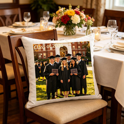 Custom graduation photo pillow resting on a chair at a festive graduation party dinner table, surrounded by flowers and candles. A charming touch for graduation celebrations and family gatherings.