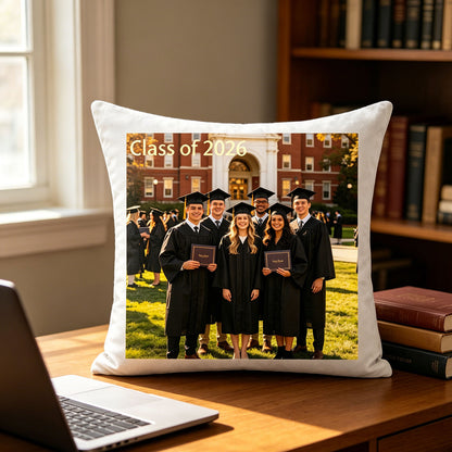 Custom graduation photo pillow resting on a wooden study desk, next to a laptop and college textbooks. An inspiring decor piece for graduates starting their careers or continuing their education.
