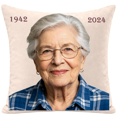 Personalized memorial throw pillow with a modern portrait of an elderly woman, featuring custom birth and passing years (1942-2024), sympathy keepsake for remembering a mother or grandmother, soft cream fabric.