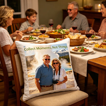 Custom travel photo pillow placed on a dining chair at a cozy family dinner table, surrounded by plates of food and wine glasses. A warm, homey scene showing the pillow as a conversation starter during family gatherings about travel memories.
