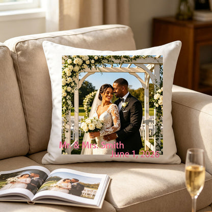 Custom wedding photo pillow resting on a cozy beige sofa, next to a wedding photo album and a glass of champagne. A sweet reminder of the couple’s love story in everyday home life.
