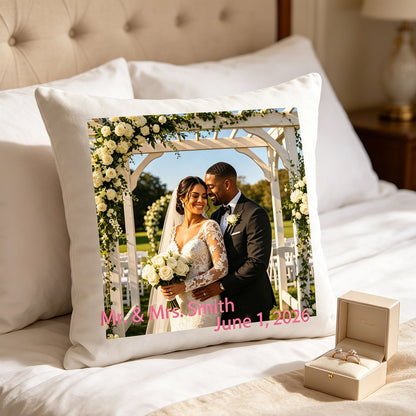 Personalized wedding keepsake pillow placed on a plush white bed, next to a box of wedding rings. A romantic addition to the master bedroom, celebrating the couple’s special bond.
