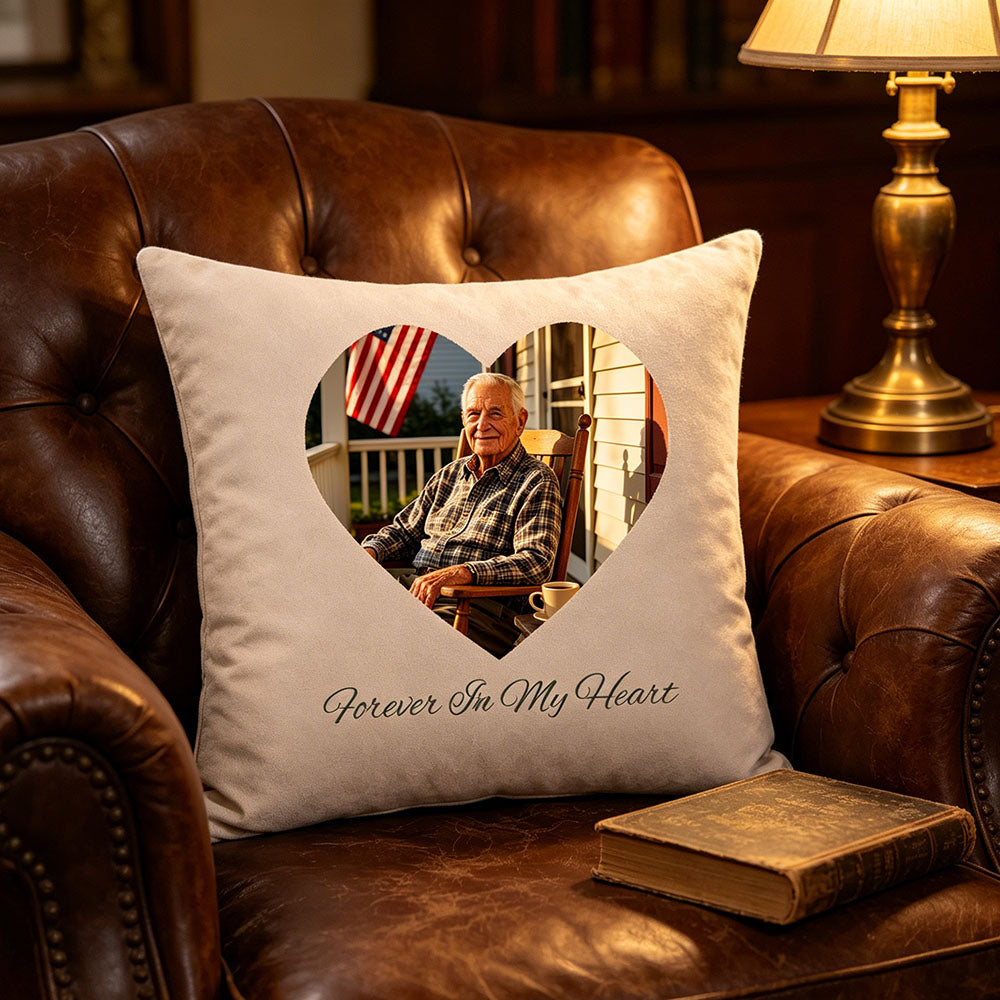 Premium velvet memorial pillow on vintage leather couch with warm ambient lighting
