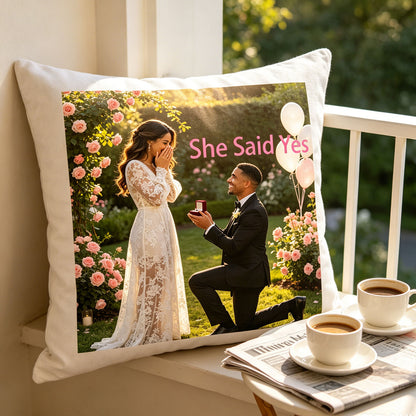 Custom engagement photo pillow resting on a sunlit balcony ledge, with coffee cups and a newspaper nearby. A cozy morning reminder of the couple’s special proposal day, ideal for newlywed home decor.