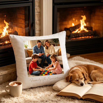 Custom family keepsake pillow resting on a plush rug in front of a lit fireplace, with a sleeping dog and open book nearby. A warm, cozy scene showing the pillow as a reminder of family love in quiet evenings at home.