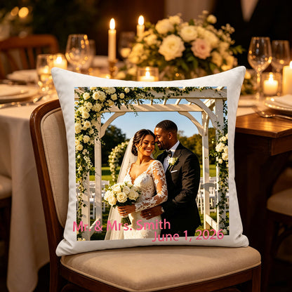 Custom wedding photo pillow resting on a chair at a romantic wedding reception table, surrounded by candles and flowers. A charming touch for wedding decor or anniversary celebrations.
