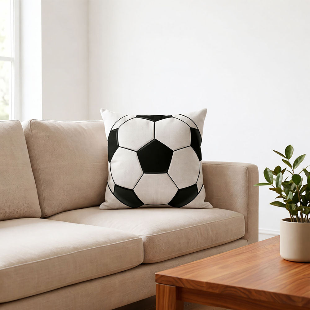 Classic black white soccer print throw pillow placed on beige living room sofa, World Cup sports themed home decor cushion for football fan living space, customizable with your favorite team or player photo.